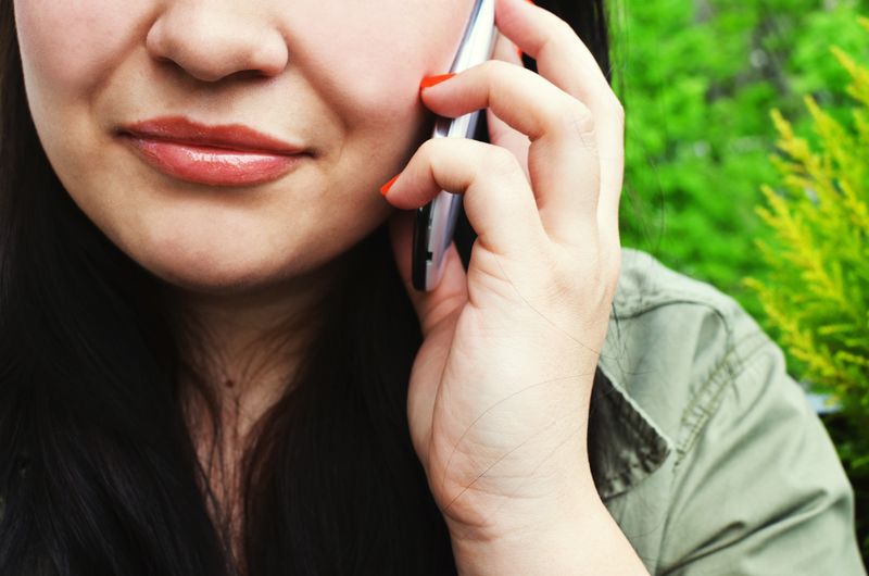 A close-up of a woman smiling on the phone